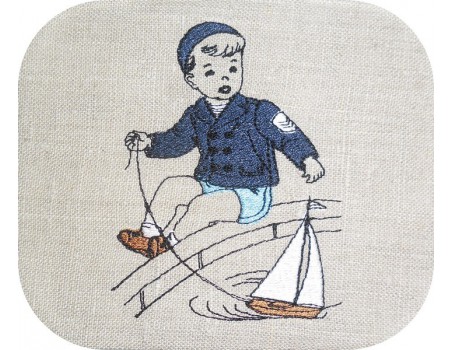 Motif de broderie machine garçon avec son bateau