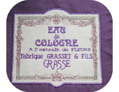 Motif de broderie machine cadre fleurs publicité eau de cologne